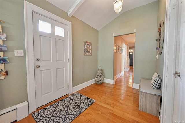 entrance foyer with lofted ceiling, light hardwood / wood-style flooring, and a baseboard heating unit