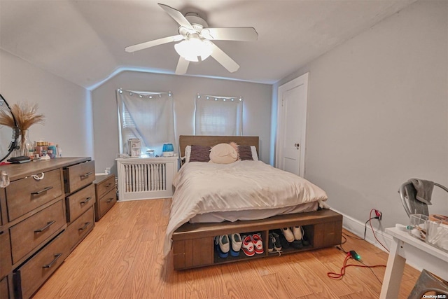 bedroom with light hardwood / wood-style floors, ceiling fan, and lofted ceiling