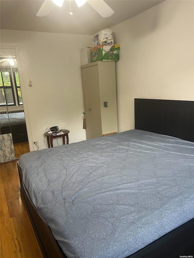 bedroom with hardwood / wood-style floors and ceiling fan