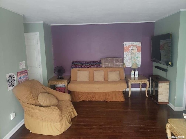 bedroom with dark hardwood / wood-style flooring and crown molding