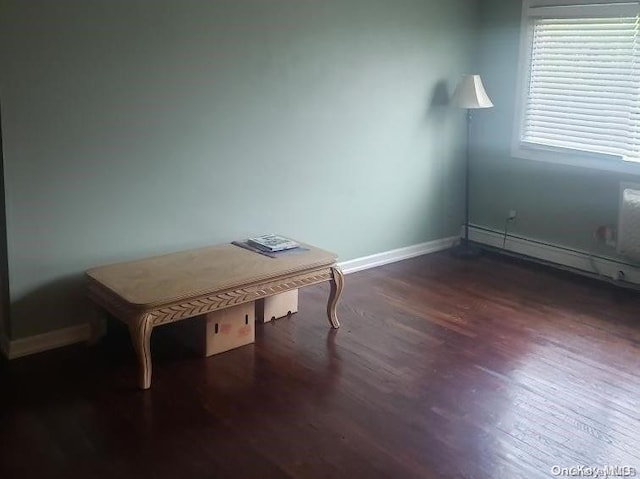 interior space featuring dark hardwood / wood-style floors and a baseboard heating unit