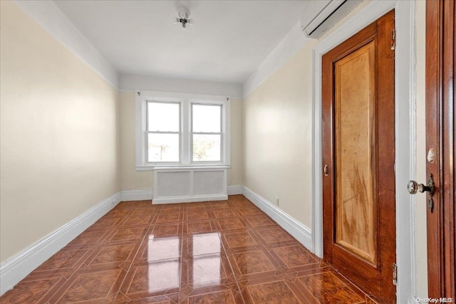 spare room with a wall mounted air conditioner and dark tile patterned floors