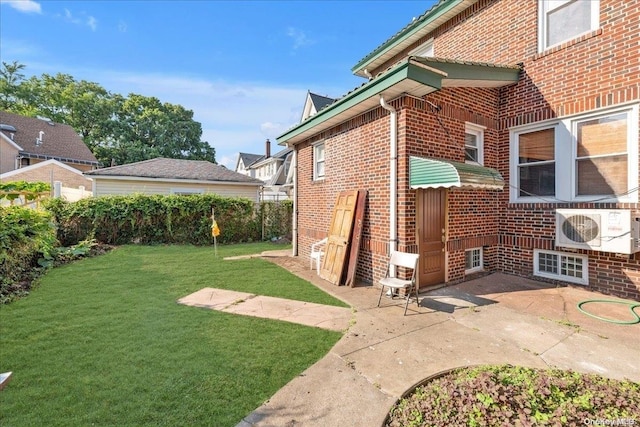 exterior space featuring ac unit, a yard, and a patio area