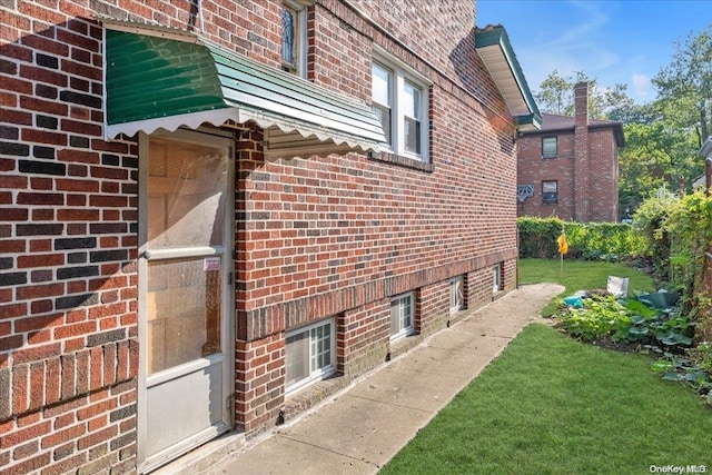 view of side of home with a lawn