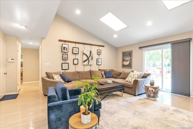 living room with vaulted ceiling with skylight and light wood-type flooring