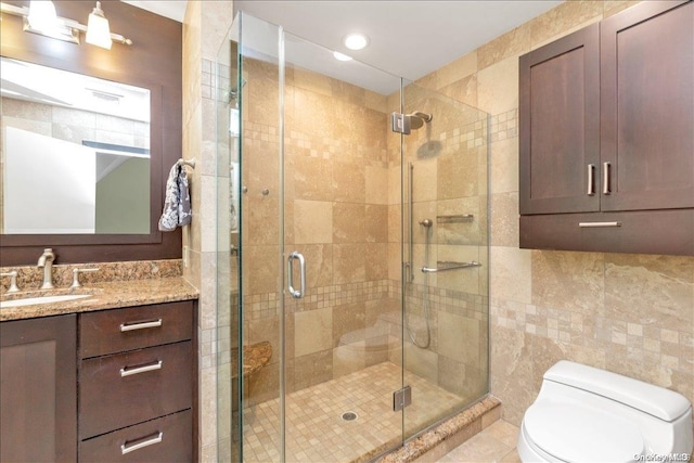 bathroom featuring toilet, an enclosed shower, tile walls, and vanity