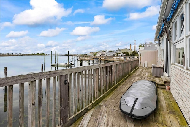 deck with a boat dock and a water view