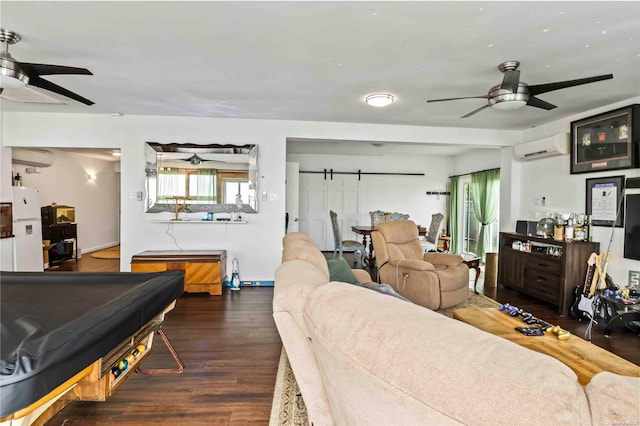 living room with ceiling fan, a barn door, an AC wall unit, billiards, and dark hardwood / wood-style floors