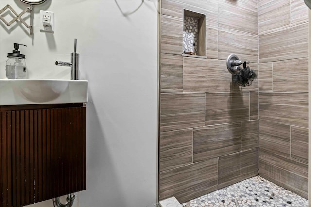 bathroom featuring vanity and a tile shower