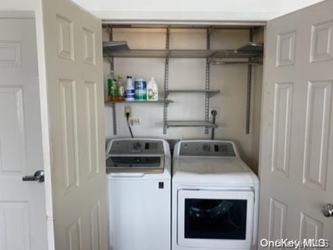 washroom featuring washing machine and dryer