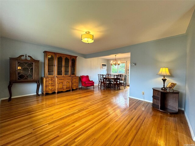 sitting room featuring hardwood / wood-style floors and a notable chandelier