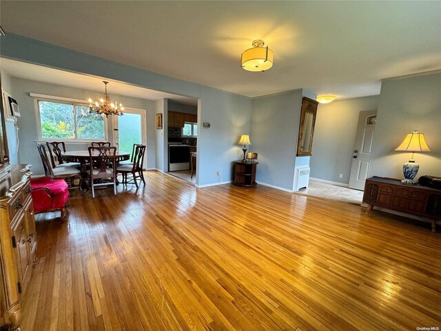 living room with light hardwood / wood-style floors and a chandelier