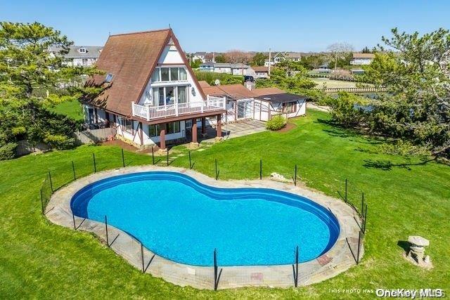 view of swimming pool with a lawn