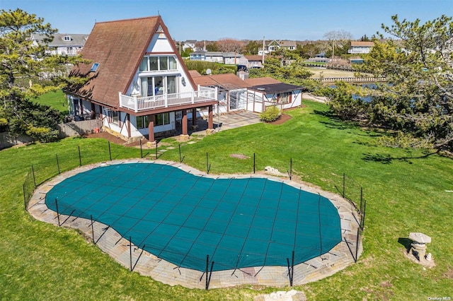 view of swimming pool featuring a patio area and a yard