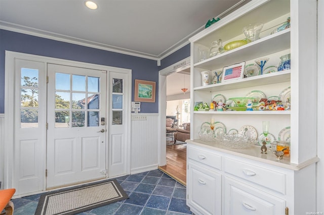 doorway featuring crown molding and dark wood-type flooring