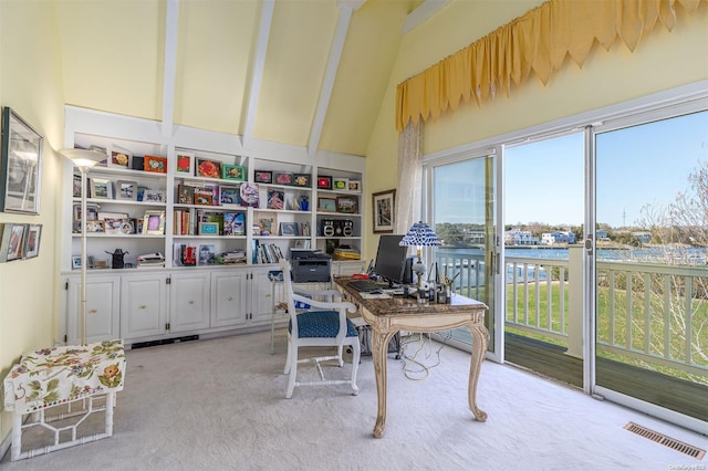 carpeted office space with beamed ceiling and high vaulted ceiling