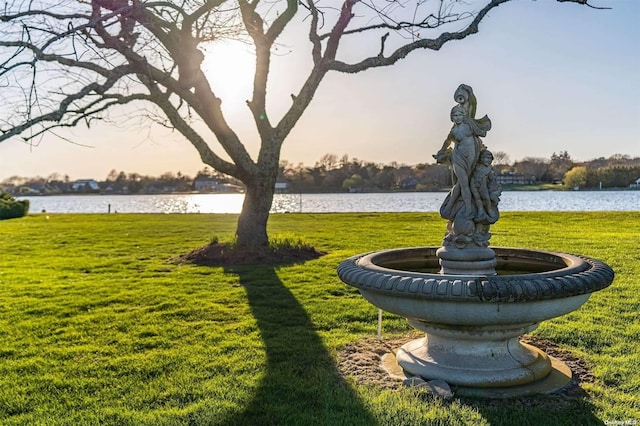 surrounding community featuring a yard and a water view