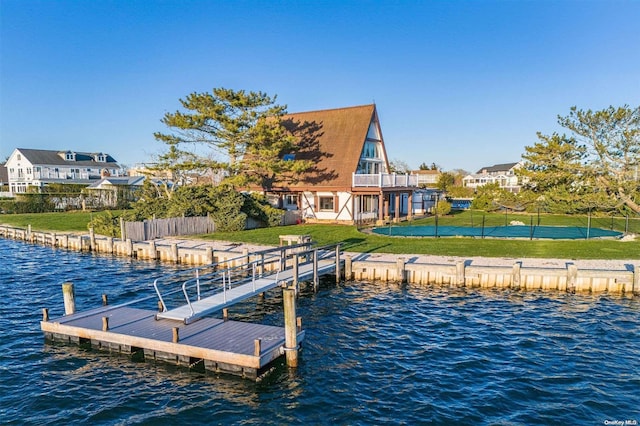 view of dock featuring a water view and a lawn