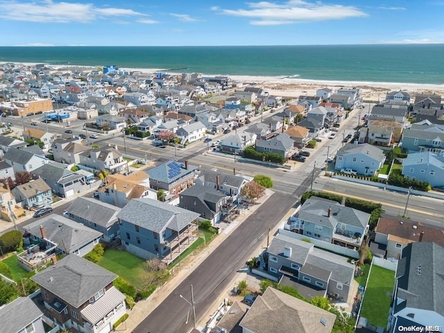 birds eye view of property with a view of the beach and a water view