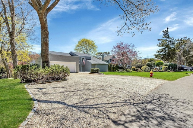 view of home's exterior with a garage and a yard