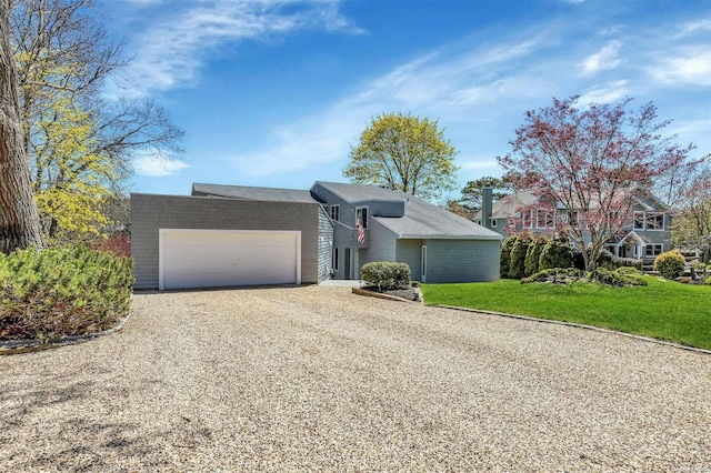 view of front of home with a garage and a front lawn