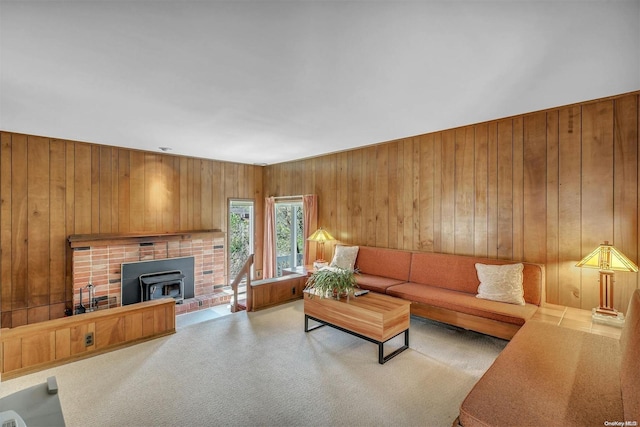 living room with wood walls and a wood stove