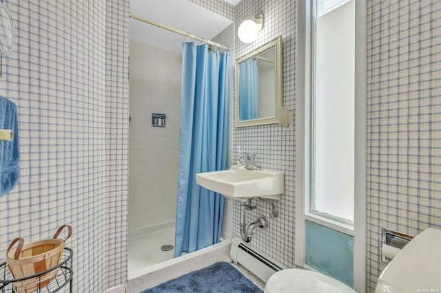 bathroom featuring curtained shower, sink, a baseboard radiator, and toilet