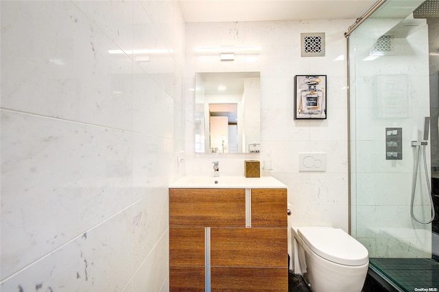 bathroom featuring vanity, tile walls, and toilet