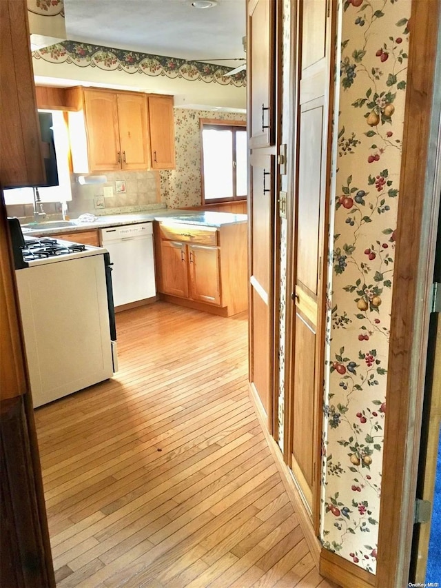 kitchen featuring white appliances and light hardwood / wood-style floors