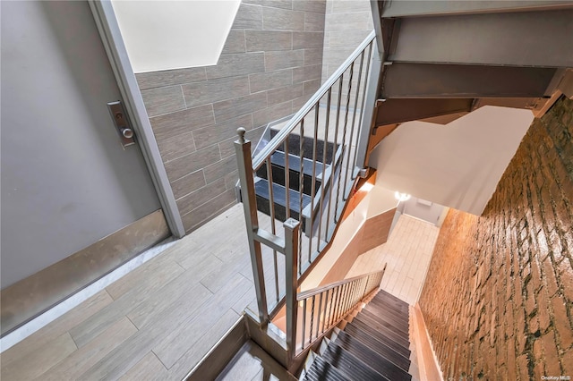 staircase featuring wood-type flooring