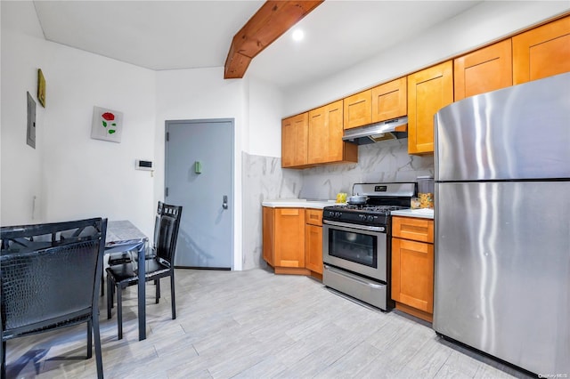 kitchen featuring beam ceiling, light wood-type flooring, stainless steel appliances, and tasteful backsplash