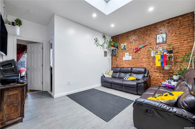 living room with light wood-type flooring, brick wall, and a skylight