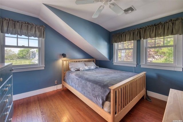 bedroom with lofted ceiling, ceiling fan, and dark wood-type flooring