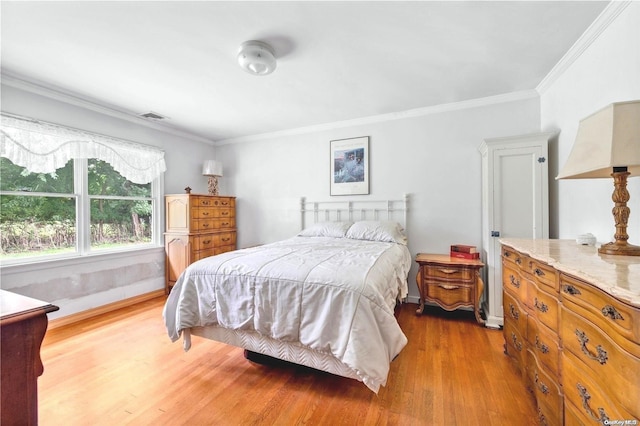 bedroom featuring ornamental molding and wood-type flooring