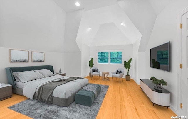 bedroom featuring lofted ceiling and hardwood / wood-style floors