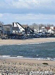 property view of water featuring a beach view