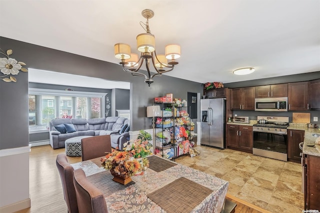 dining room with an inviting chandelier and a baseboard heating unit