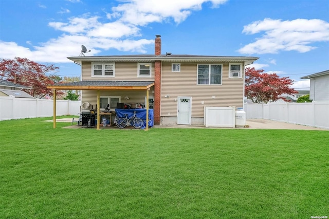 back of house with a yard and a patio area