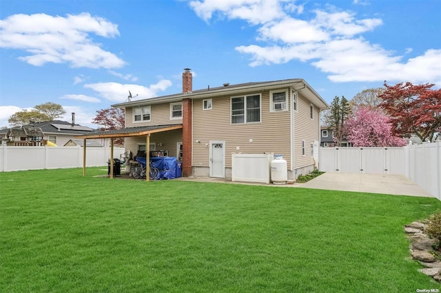 rear view of property with a yard and a patio