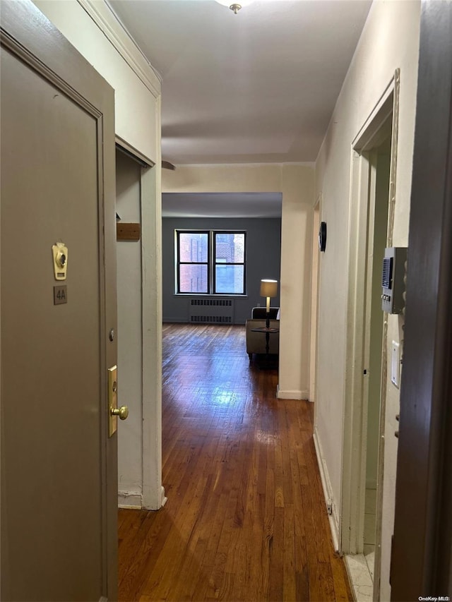 hall with radiator heating unit and dark wood-type flooring