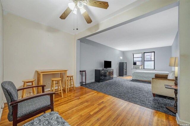 living room with hardwood / wood-style flooring and ceiling fan