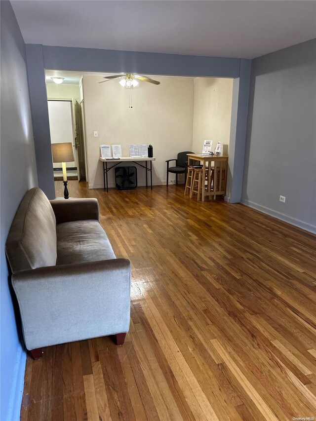 living room with hardwood / wood-style floors and ceiling fan