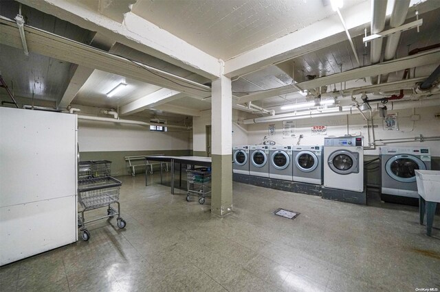 basement with independent washer and dryer and white refrigerator