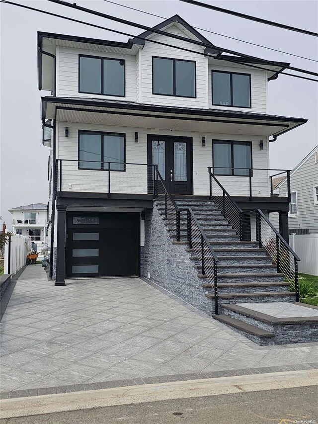 47 Pershing Ave, Babylon, NY 11702 - view of front of home featuring stairs, french doors, and a garage