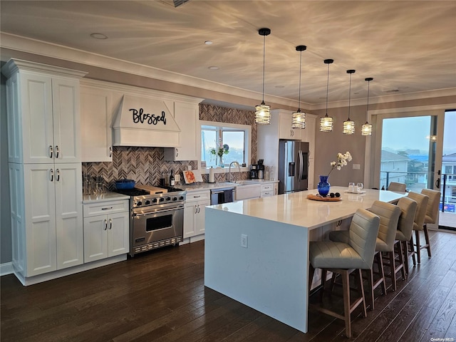47 Pershing Ave, Babylon, NY 11702 - kitchen with appliances with stainless steel finishes, a center island, white cabinetry, premium range hood, and dark wood-style flooring