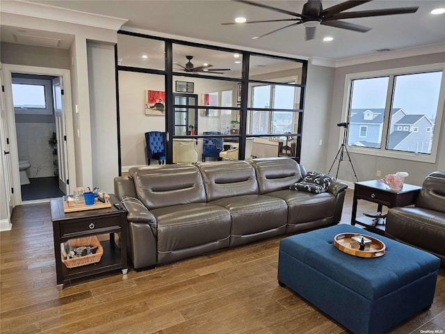 cinema with wood-type flooring and crown molding