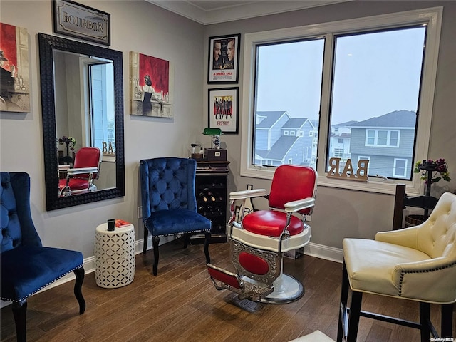 sitting room with wood-type flooring and crown molding