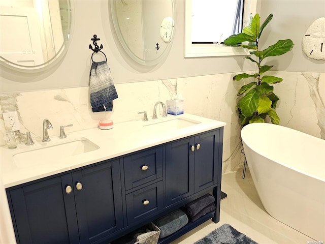 bathroom featuring a bathing tub, vanity, and tile walls