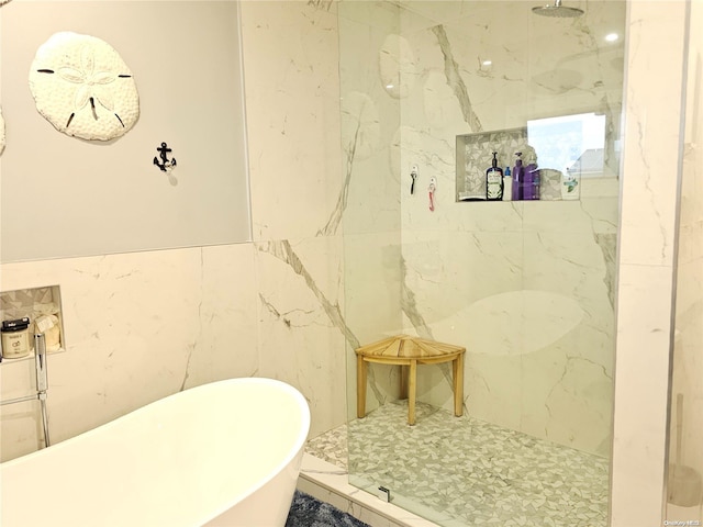 bathroom featuring tile walls and independent shower and bath