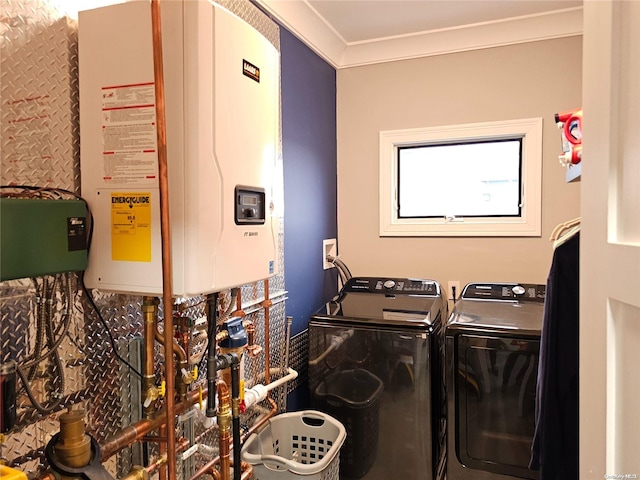 laundry area featuring tankless water heater, washer and clothes dryer, and ornamental molding